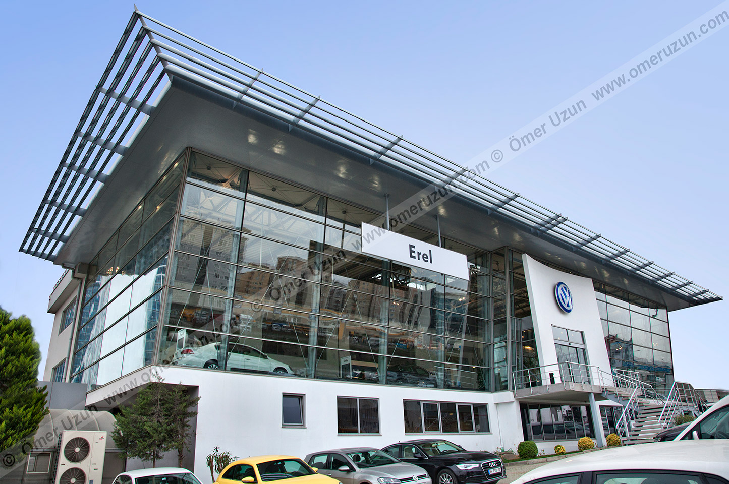 Erel Automotive Car Showroom exterior corner day view with cars